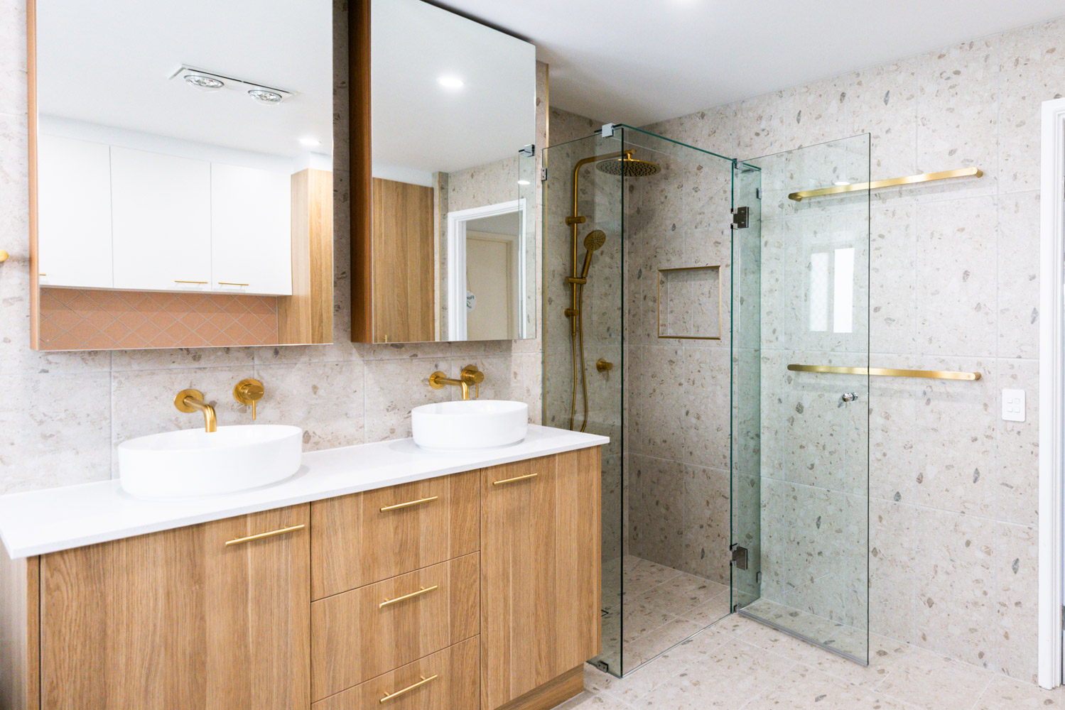 Bathroom renovation Rochedale South — terrazzo tile, double timber vanity and brushed gold fixtures