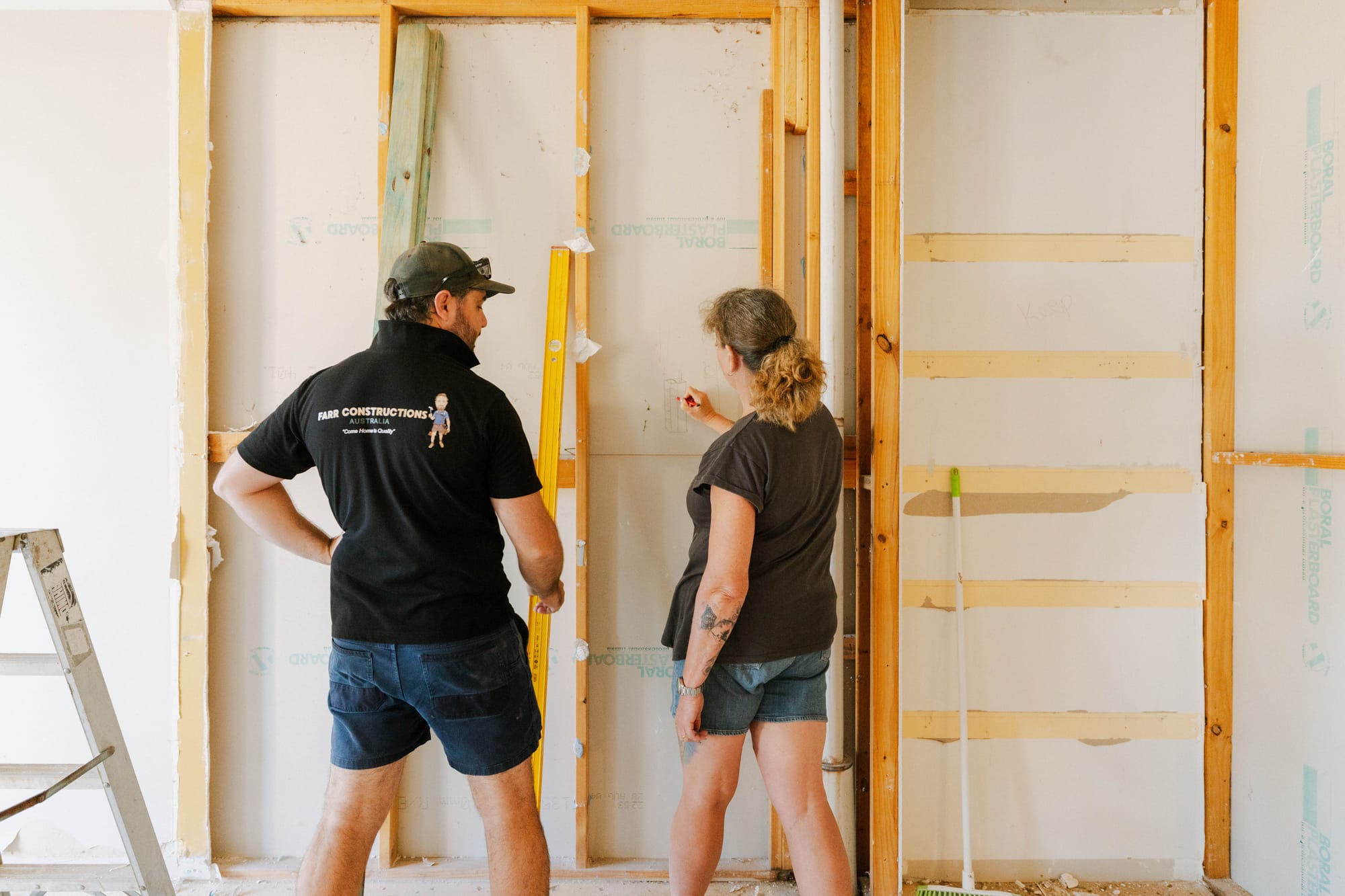 Tomas with a client reviewing wall framing